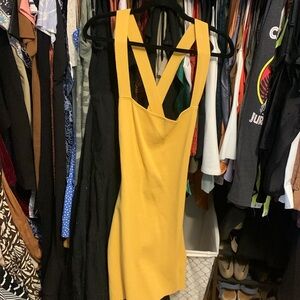 Mustard color bodycon dress with criss-cross open back